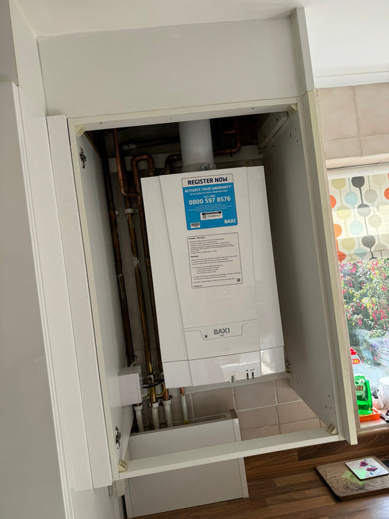 Boiler fitted neatly inside a kitchen cupboard