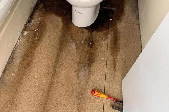 Water damage to a bathroom floor caused by a hidden leak