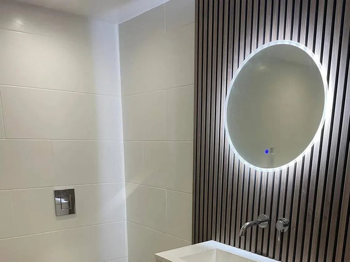 Completed bathroom with a slatted feature wall and lit mirror
