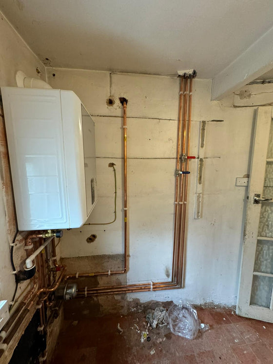 Boiler installation part way through, pipework being run in