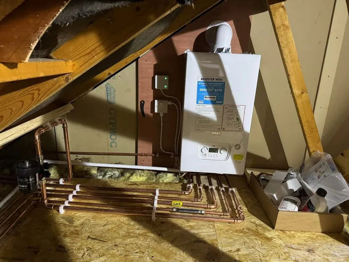 Boiler installed in a loft with new copper pipework and insulation