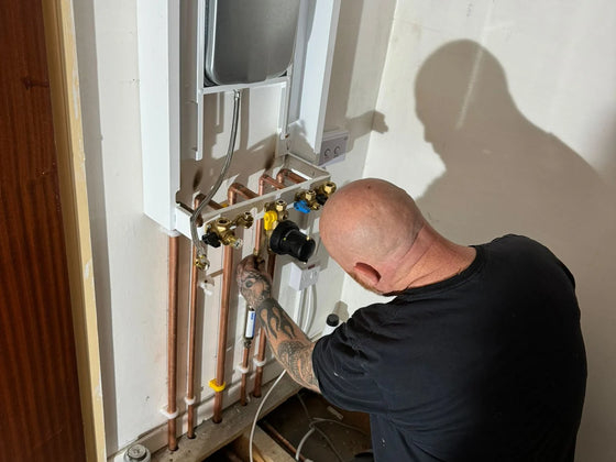 Engineer diagnosing a fault on a domestic boiler