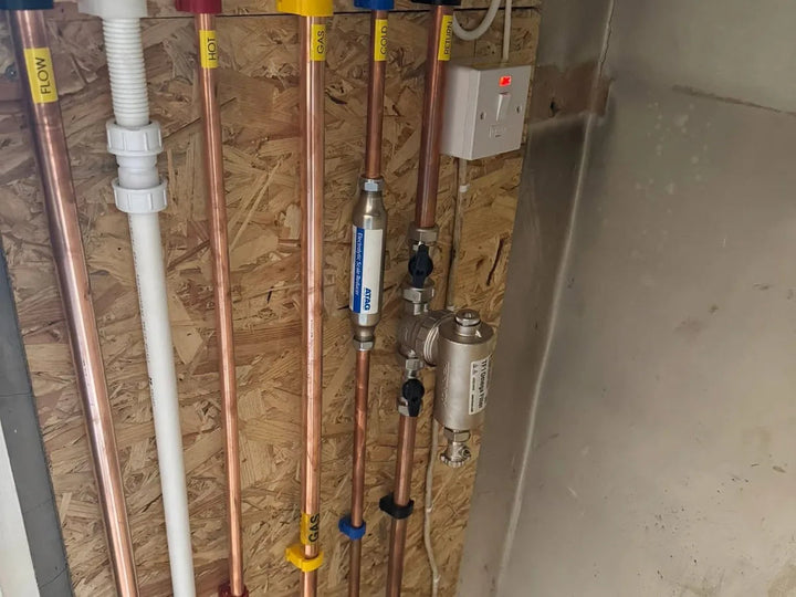 Labelled copper service risers installed on a commercial fit out