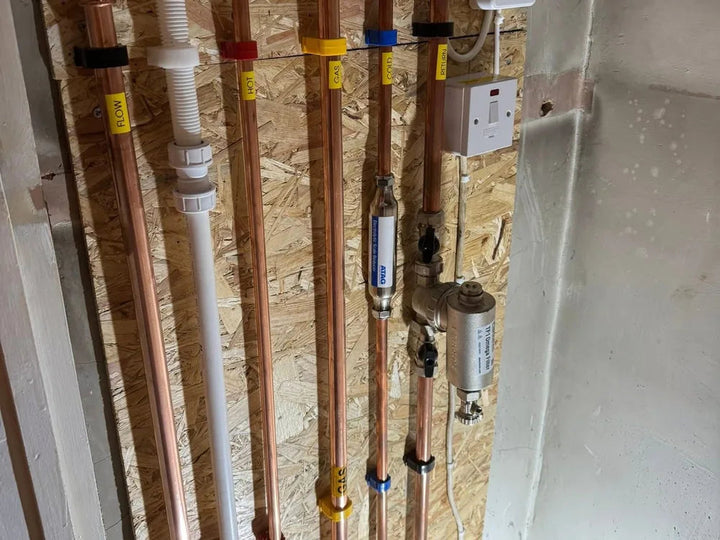 Copper manifold and labelled services on a commercial installation