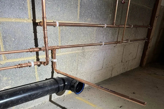 Copper services and soil pipe run at ceiling level on a commercial job