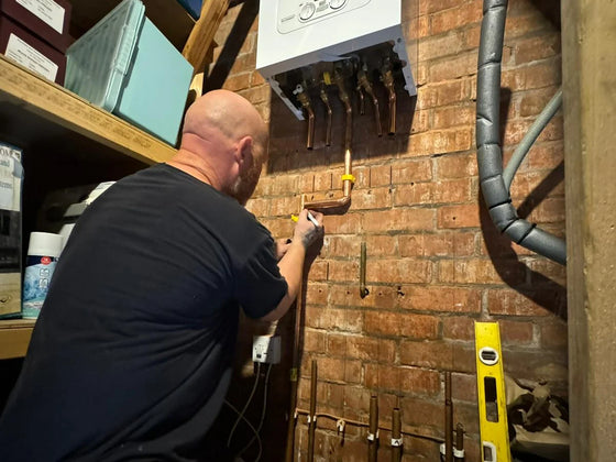 Gas Safe registered engineer at work on a heating system