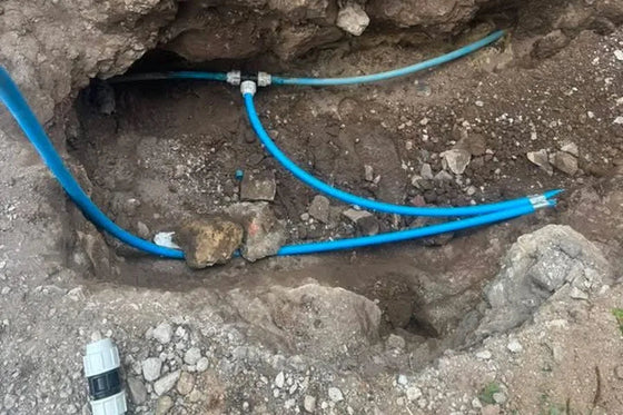 New blue MDPE water main jointed and connected in the excavation