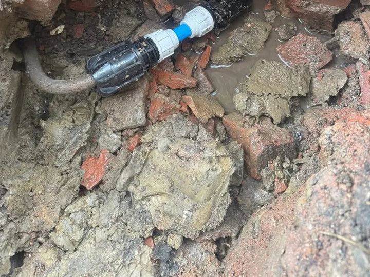 New supply pipe and connector in the excavation at the property wall